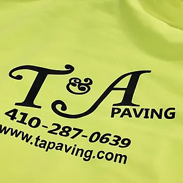A safety yellow hoodie screen printed in black for T&A Paving