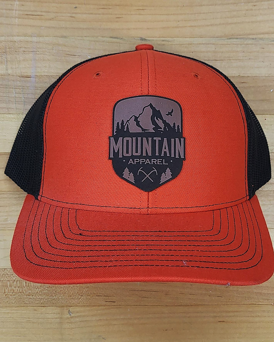 A leather Mountain Apparel patch cap