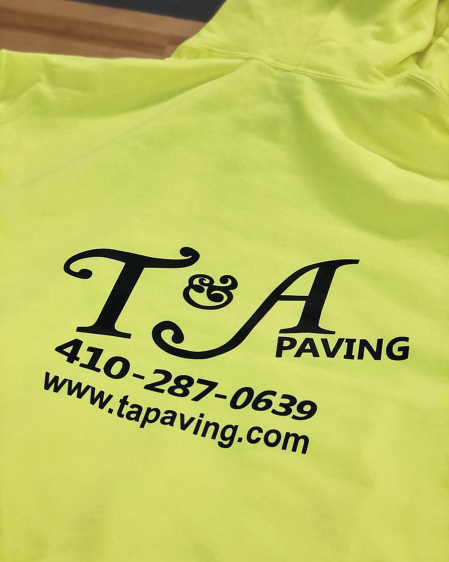 A safety yellow hoodie screen printed in black for T&A Paving